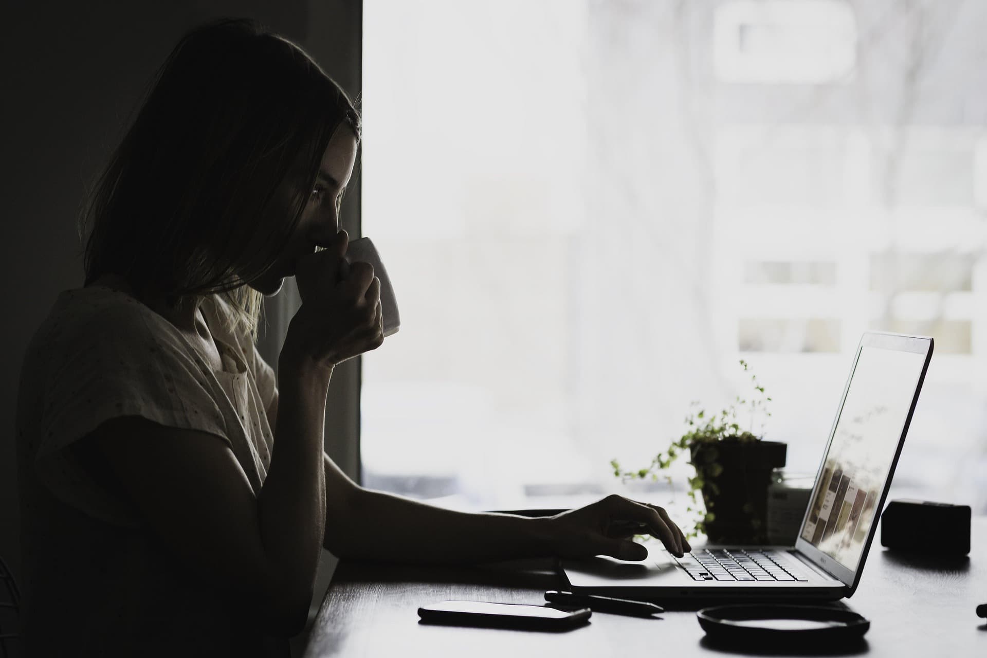 Person working at a laptop in a dark office, used for the Futurize Labs AI automation finder that maps workflows and automation opportunities.